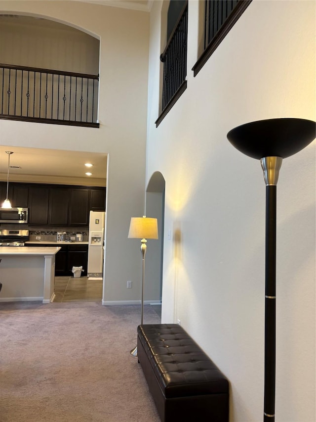 331 W Bend Dr, League City, TX 77573 - living room featuring light carpet, a high ceiling, and ornamental molding