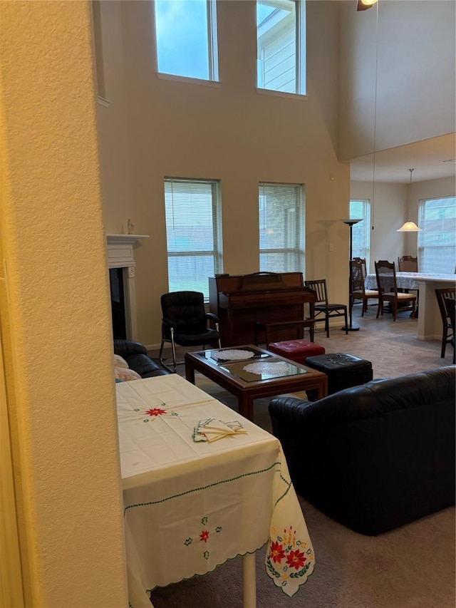 331 W Bend Dr, League City, TX 77573 - carpeted living room featuring a high ceiling and a glass covered fireplace
