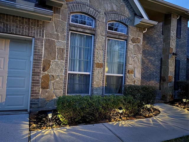 331 W Bend Dr, League City, TX 77573 - property entrance featuring stone siding and a garage