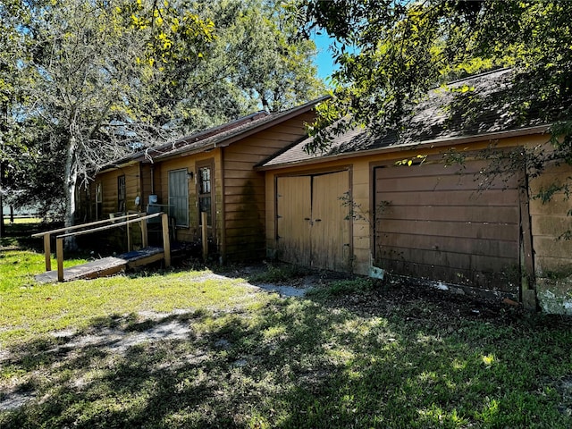 view of side of home with a yard