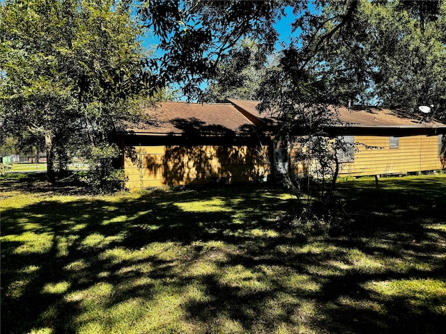 view of property exterior with a yard