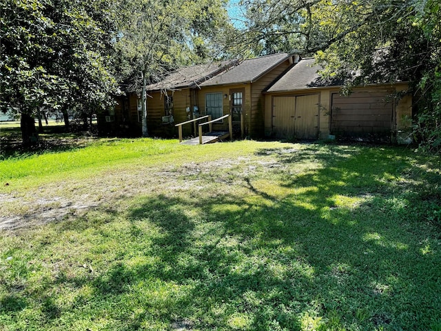 235 W Hartel St, Sour Lake, TX 77659 - view of yard featuring a garage