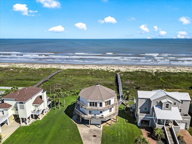 drone / aerial view with a water view and a beach view