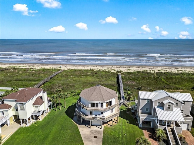 birds eye view of property with a view of the beach and a water view