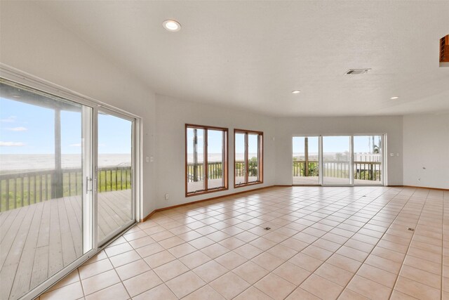 interior space featuring baseboards, visible vents, recessed lighting, and light tile patterned floors