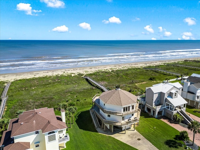 drone / aerial view featuring a water view and a beach view