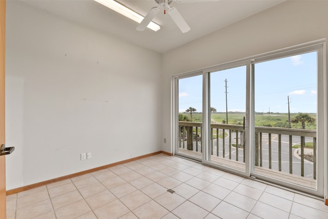 tiled spare room featuring ceiling fan