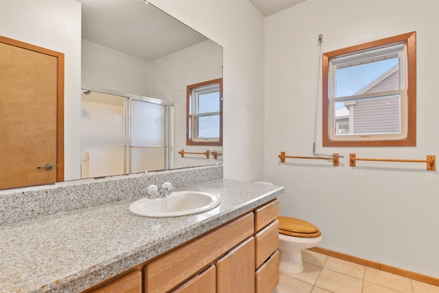 full bath with baseboards, toilet, tile patterned floors, vanity, and a stall shower