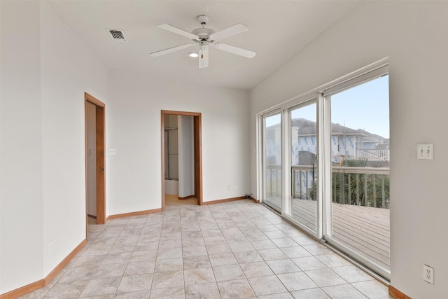 empty room featuring baseboards, ceiling fan, and visible vents