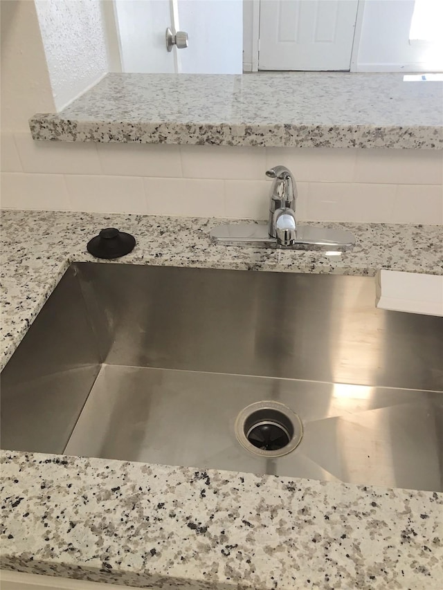 8733 Victorian Village Dr, Houston, TX 77071 - details featuring light stone countertops and a sink