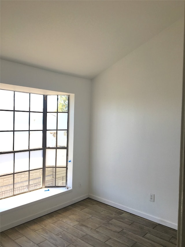 spare room with dark hardwood / wood-style flooring