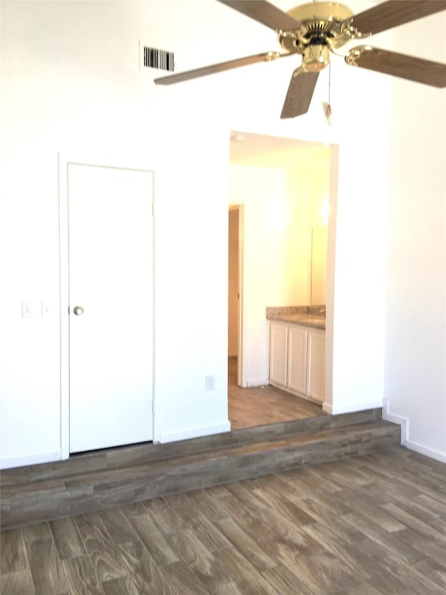 8733 Victorian Village Dr, Houston, TX 77071 - spare room with baseboards, a ceiling fan, dark wood-style flooring, and visible vents