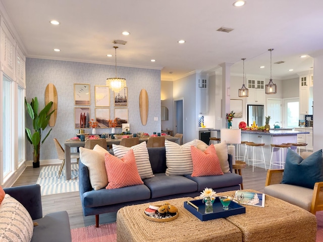 living area featuring wallpapered walls, recessed lighting, crown molding, baseboards, and wood finished floors