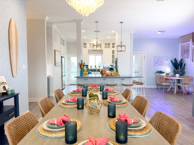 dining room featuring crown molding, baseboards, light wood-type flooring, and recessed lighting