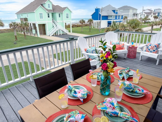 deck featuring a residential view, a yard, and a water view