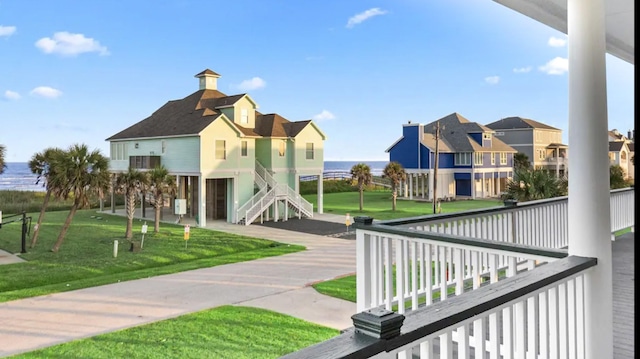 view of home's community featuring a yard, stairs, and a residential view