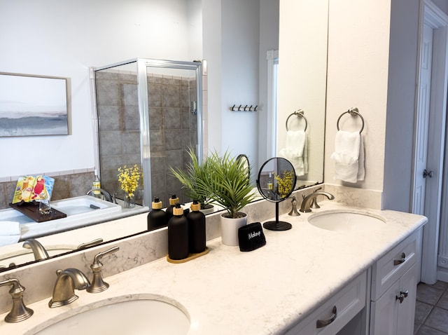 full bathroom featuring a stall shower, double vanity, and tile patterned flooring