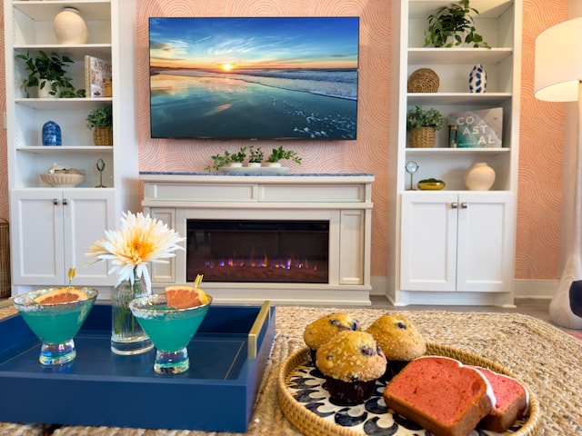 living area featuring a glass covered fireplace