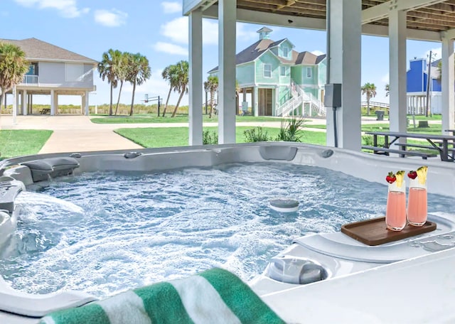 view of pool featuring a yard and a hot tub