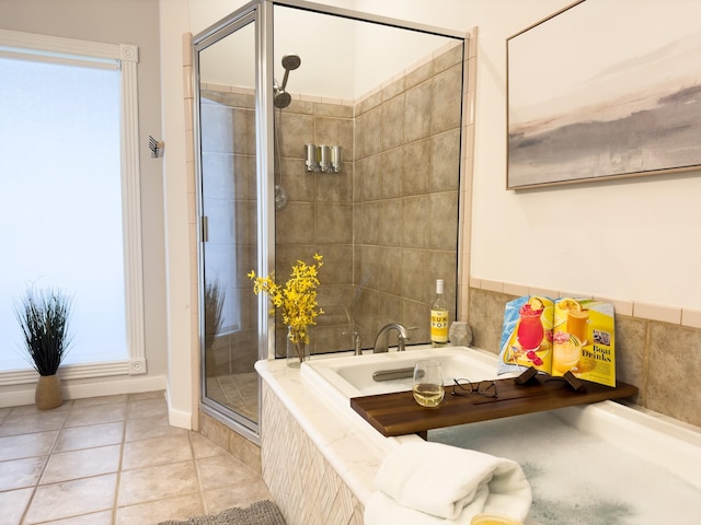 bathroom featuring a shower stall, tile patterned flooring, and a bath