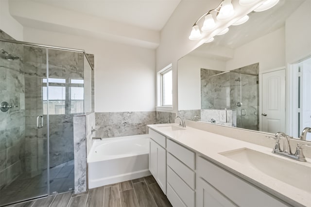 bathroom with independent shower and bath and vanity