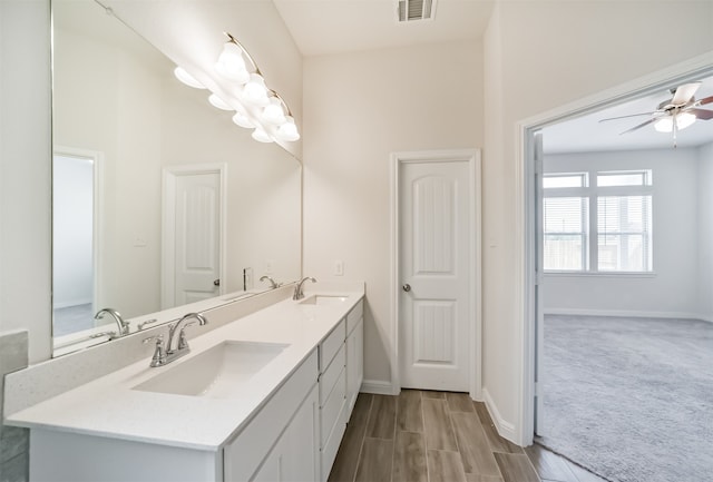 bathroom with ceiling fan, vanity, and hardwood / wood-style flooring