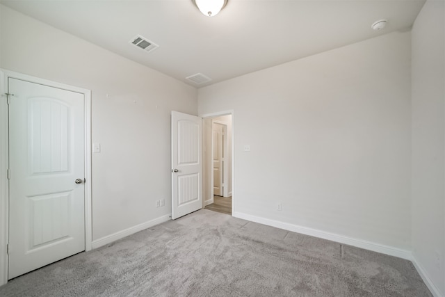 unfurnished bedroom featuring light carpet