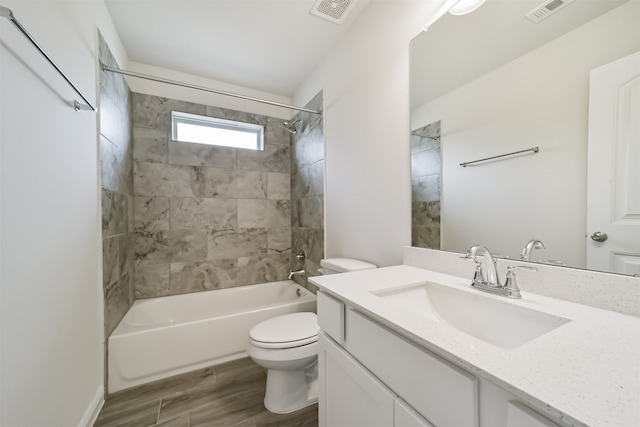 full bathroom with tiled shower / bath, vanity, toilet, and hardwood / wood-style flooring