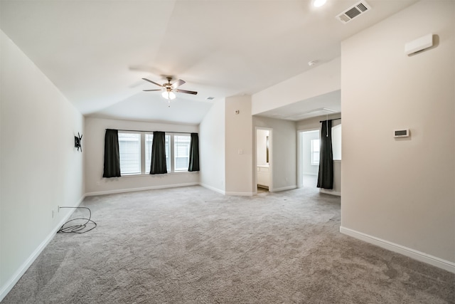 carpeted spare room featuring ceiling fan and lofted ceiling