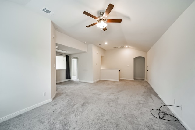 unfurnished living room with ceiling fan, lofted ceiling, and light carpet