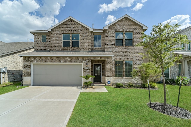 view of front of property featuring a front yard and a garage