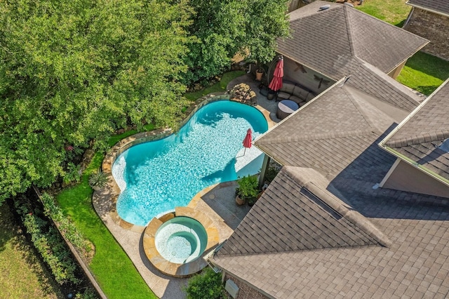 view of swimming pool featuring an in ground hot tub and a patio