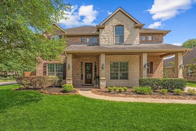 view of front of home with a front yard and covered porch