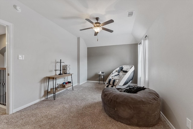 living area featuring ceiling fan, carpet flooring, and vaulted ceiling