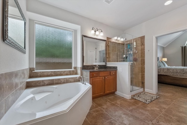 bathroom featuring shower with separate bathtub, vanity, and tile patterned floors