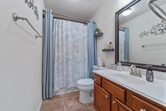 bathroom with vanity, tile patterned flooring, and toilet