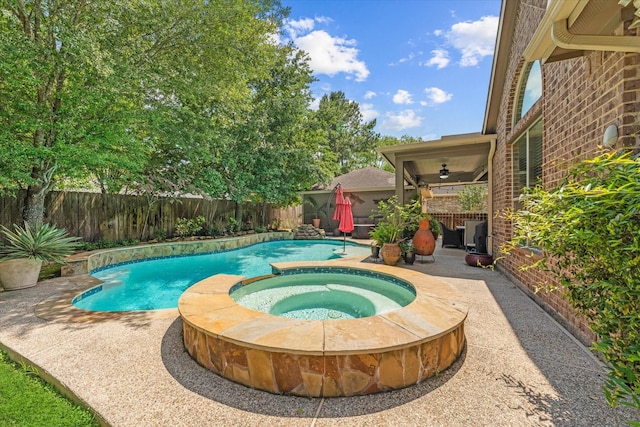 view of swimming pool with ceiling fan, an in ground hot tub, and a patio area