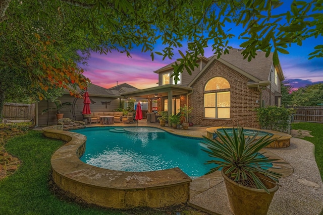 pool at dusk with a patio