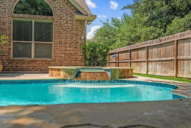 view of swimming pool featuring an in ground hot tub and pool water feature