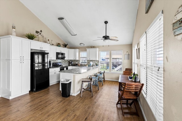 kitchen featuring black appliances, white cabinetry, and dark wood-type flooring