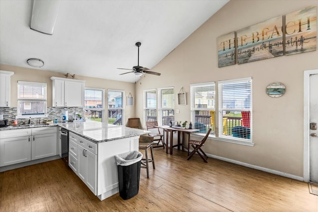 kitchen with light wood-type flooring, white cabinetry, and ceiling fan