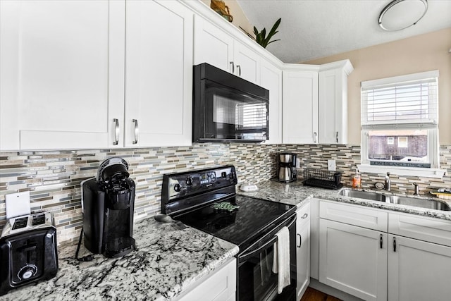 kitchen featuring white cabinets, sink, a textured ceiling, backsplash, and black appliances