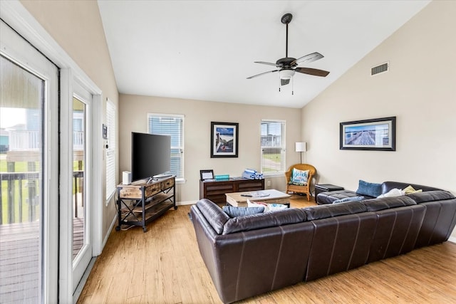 living room featuring light hardwood / wood-style floors, vaulted ceiling, and ceiling fan