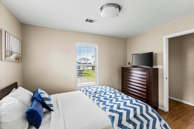 bedroom with hardwood / wood-style flooring