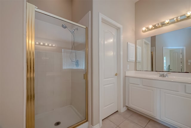 bathroom featuring tile patterned floors, a shower with door, and vanity