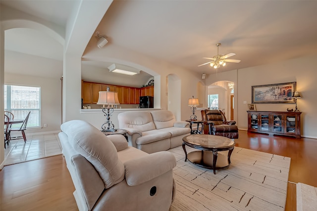 living room featuring ceiling fan and light wood-type flooring