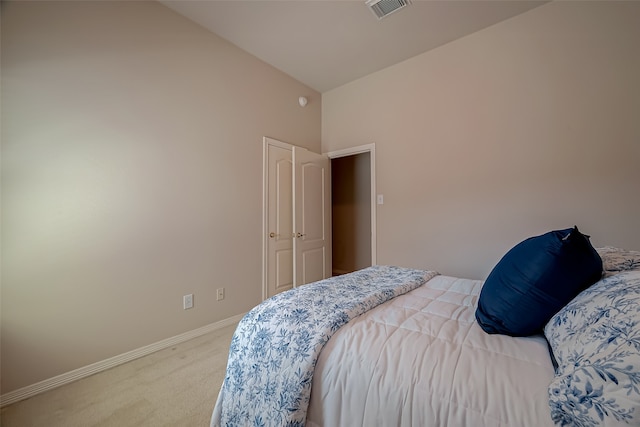 bedroom with carpet and vaulted ceiling