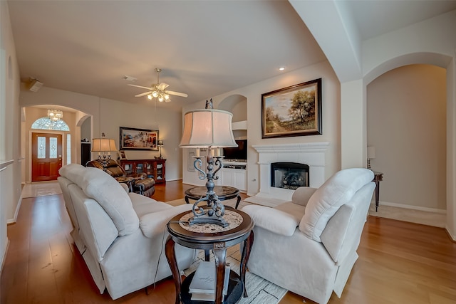 living room featuring ceiling fan and light hardwood / wood-style floors