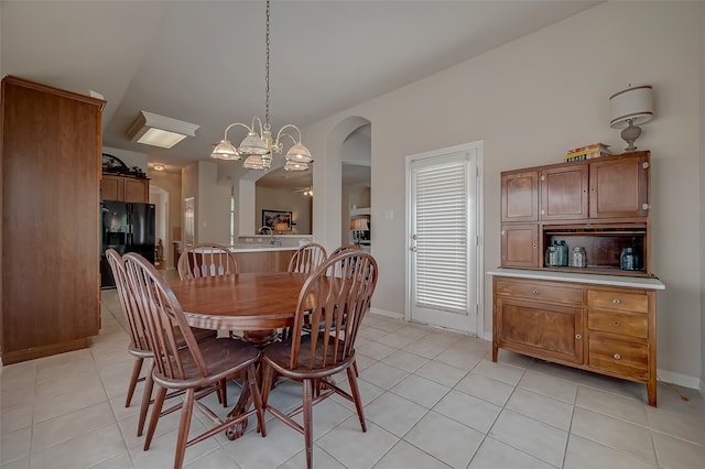 tiled dining space featuring an inviting chandelier