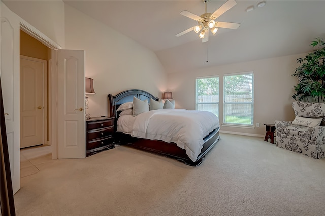 bedroom featuring ceiling fan, light colored carpet, and lofted ceiling